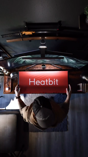 A man showing the digital display and controls of Heatbit heater