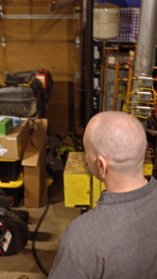 A man showing his garage with Heatbit heater inside
